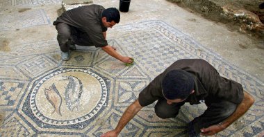 Prisoners work at a nearly 1,800-year-old decorated floor from an early Christian prayer hall discovered by Israeli archaeologists, Israel, Aug. 13, 2023. (AP Photo)