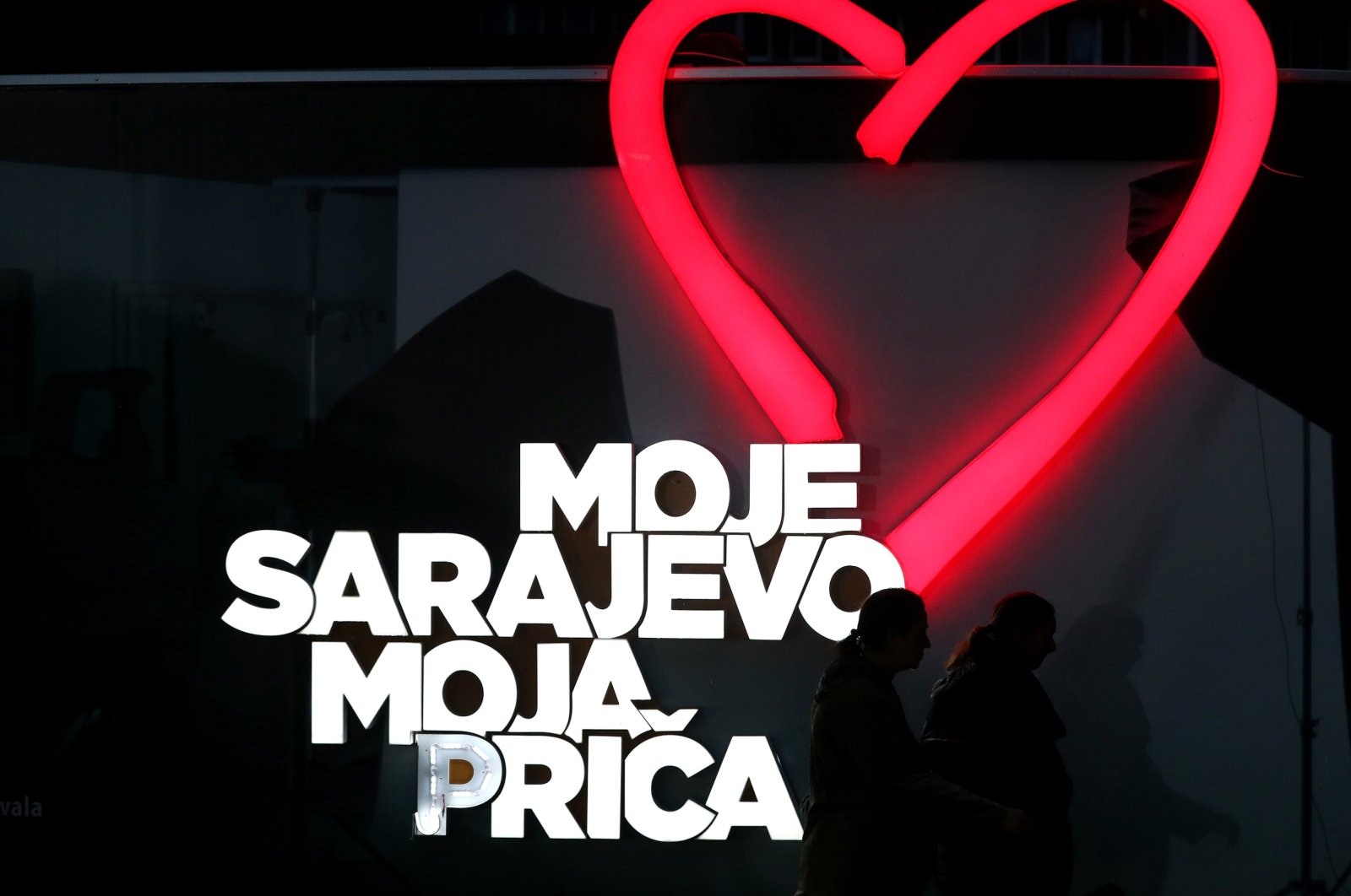 People walk in front of a poster that reads &quot;My Sarajevo, My Story&quot; during the closing of the 29th Sarajevo Film Festival in Sarajevo, Bosnia and Herzegovina, Aug. 18, 2023. (EPA Photo)