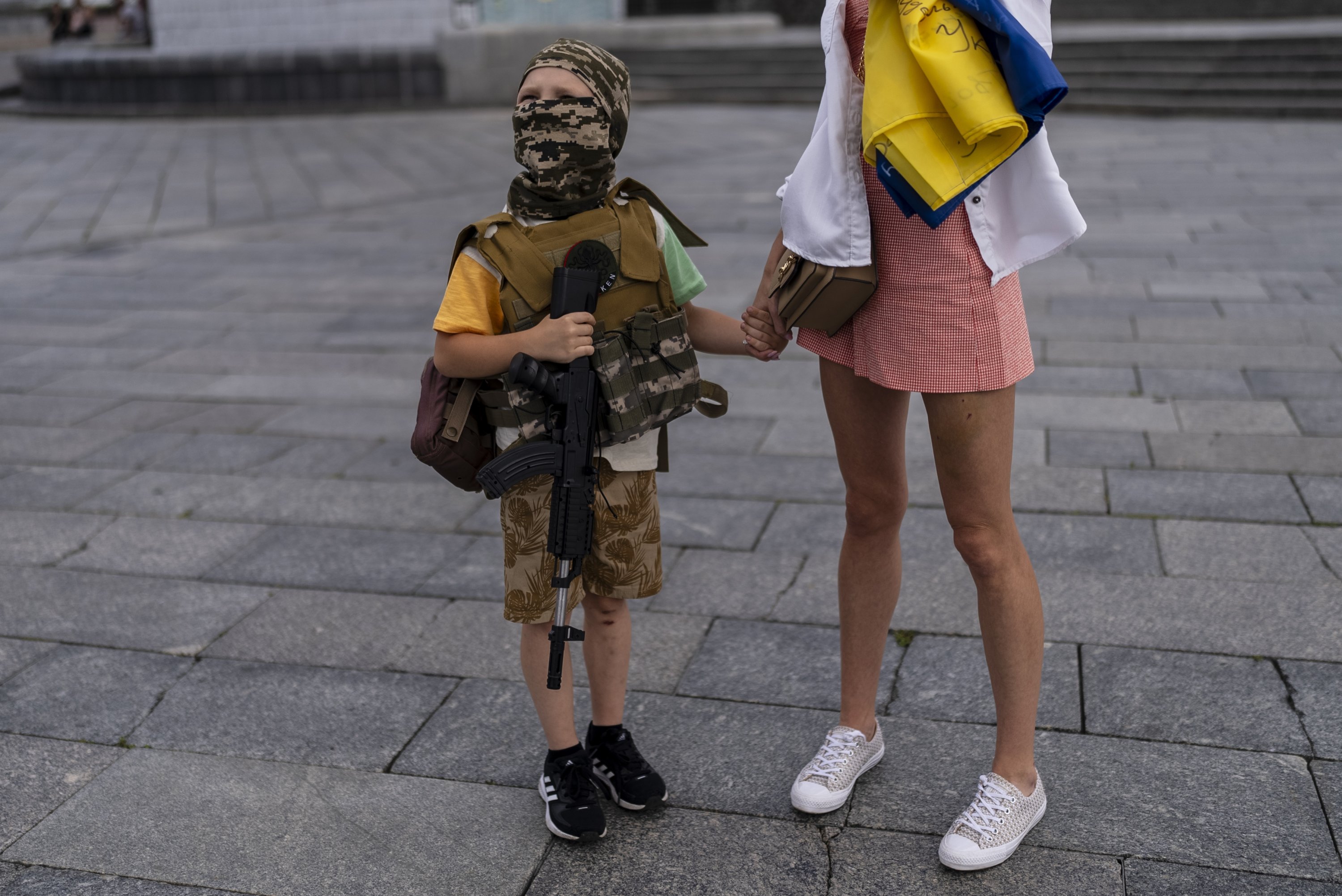 Dressed as a soldier, Artem Mihaylenko, 7, visits the Independence Square with his mother, Kyiv, Ukraine, July 9, 2023. (AP Photo)