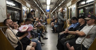 A couple share a laugh in a subway car, Kyiv, Ukraine, July 8, 2023. (AP Photo)