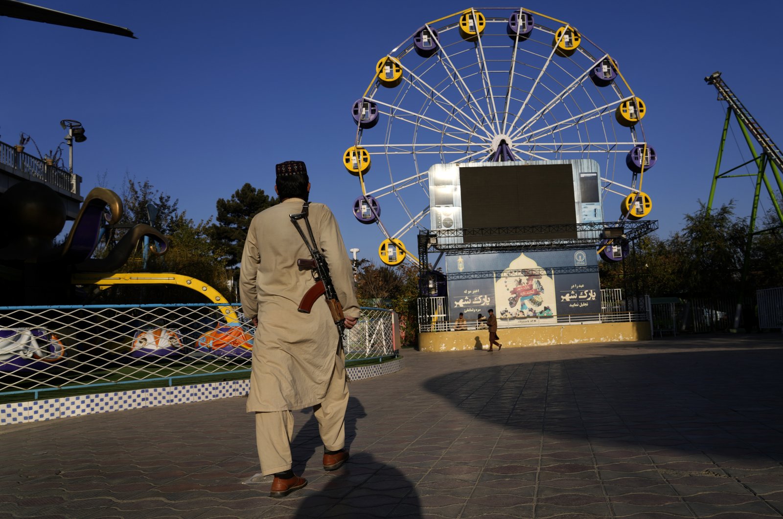 A Taliban fighter stands guard in an amusement park in Kabul, Afghanistan, Nov. 10, 2022. (AP File Photo)