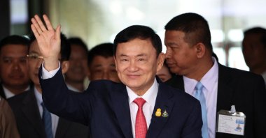 Former Thai Prime Minister Thaksin Shinawatra, who is expected to be arrested upon his return as he ends almost two decades of self-imposed exile, waves at Don Mueang airport, Bangkok, Thailand, Aug. 22, 2023. (Reuters Photo)