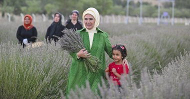 First lady Emine Erdoğan poses with a child in the lavender field, Mamak, Ankara, Türkiye, Aug. 22, 2023. (AA Photo)