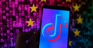 TikTok icon displayed on a phone screen with in the background European Union stars, in Brussels, Belgium, Aug. 7, 2023. (Getty Images Photo)