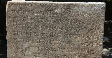 The close-up view of inscription with Greek letters found in the Metropolis ancient city, Izmir, Türkiye, Aug. 22, 2023. (DHA Photo)