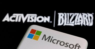 Microsoft logo on a smartphone placed on displayed Activision Blizzard logo in this illustration photo, Jan. 18, 2022. (Reuters Photo)
