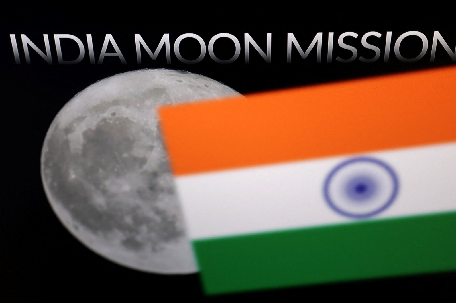 The words &quot;India Moon Mission,&quot; Moon, and an Indian flag are seen in this illustration, Aug. 21, 2023. (Reuters Photo)