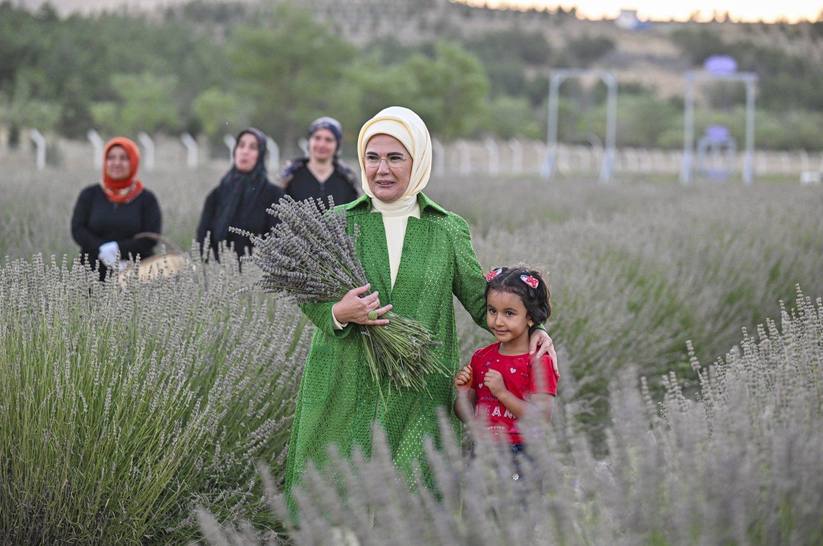 First lady Emine Erdoğan poses with a child in the lavender field, Mamak, Ankara, Türkiye, Aug. 22, 2023. (AA Photo)