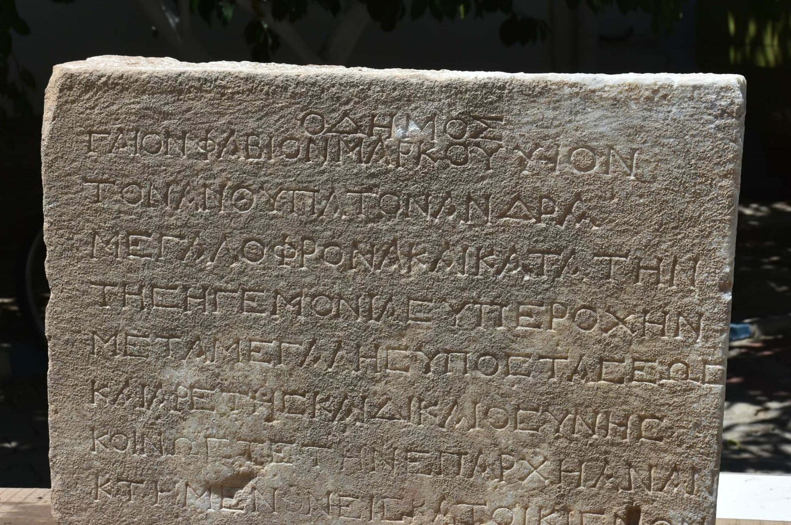 The close-up view of inscription with Greek letters found in the Metropolis ancient city, Izmir, Türkiye, Aug. 22, 2023. (DHA Photo)