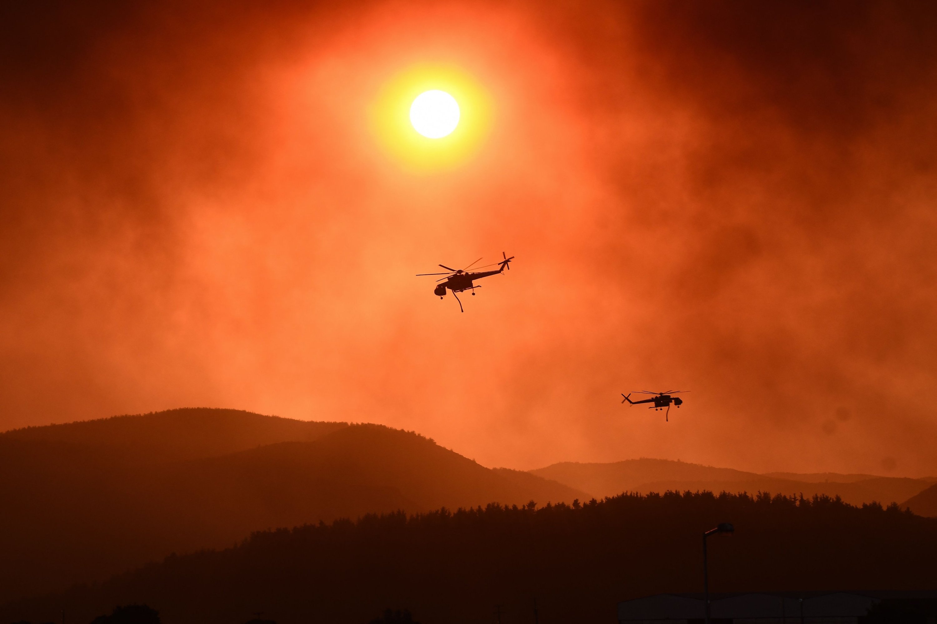 Helicopters fly overhead as wildfire rages near Alexandroupoli, northern Greece, Aug. 21, 2023. (AFP Photo)