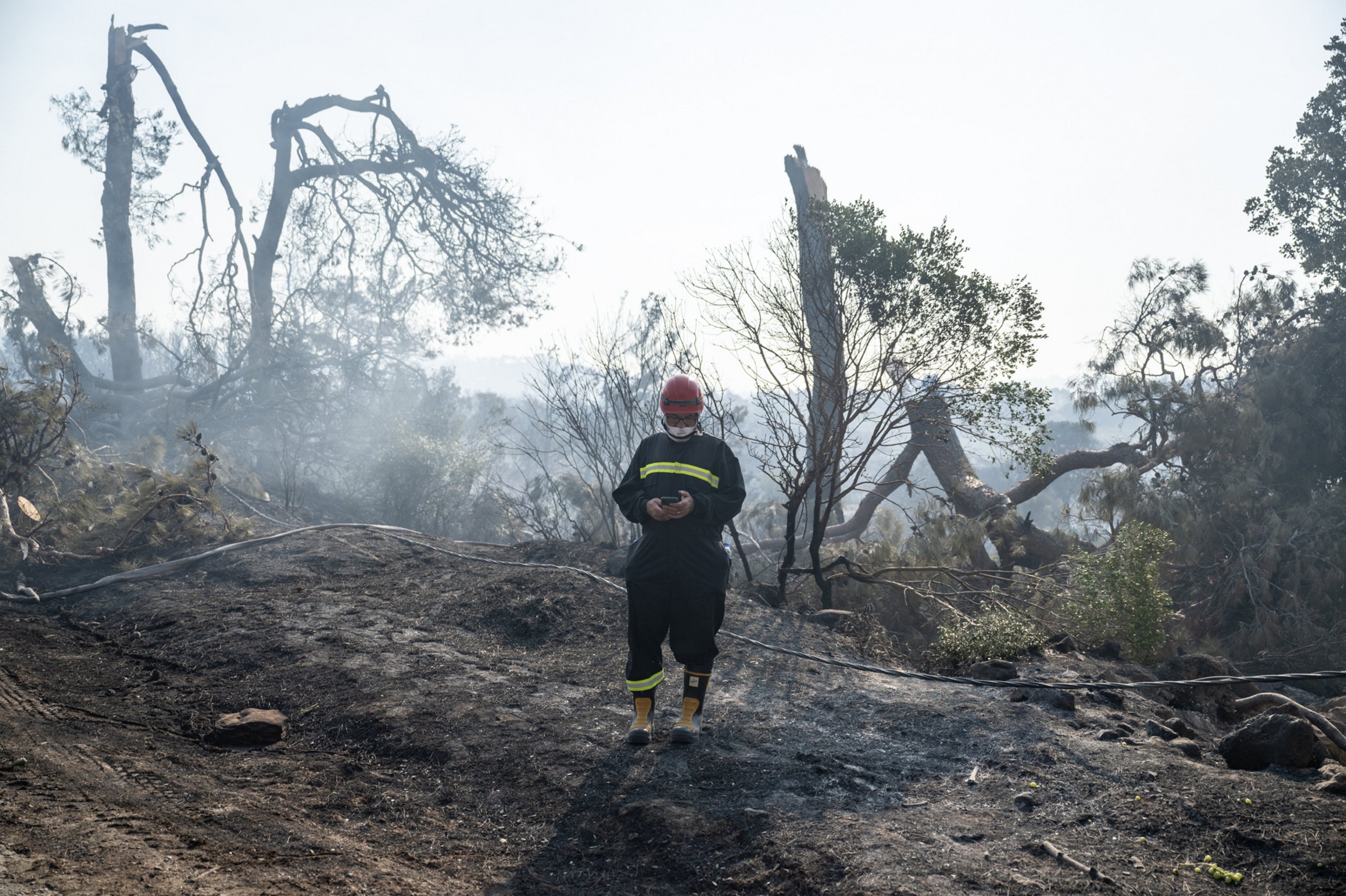 A firefighter is seen in the forest area near the Ulupınar village, Çanakkale, Türkiye, Aug. 23, 2023. (AA Photo)