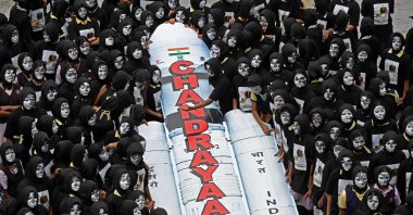 Students with painted faces surround a replica of the Chandrayaan-3 spacecraft in Chennai, India,  Aug. 22, 2023. (AFP Photo)