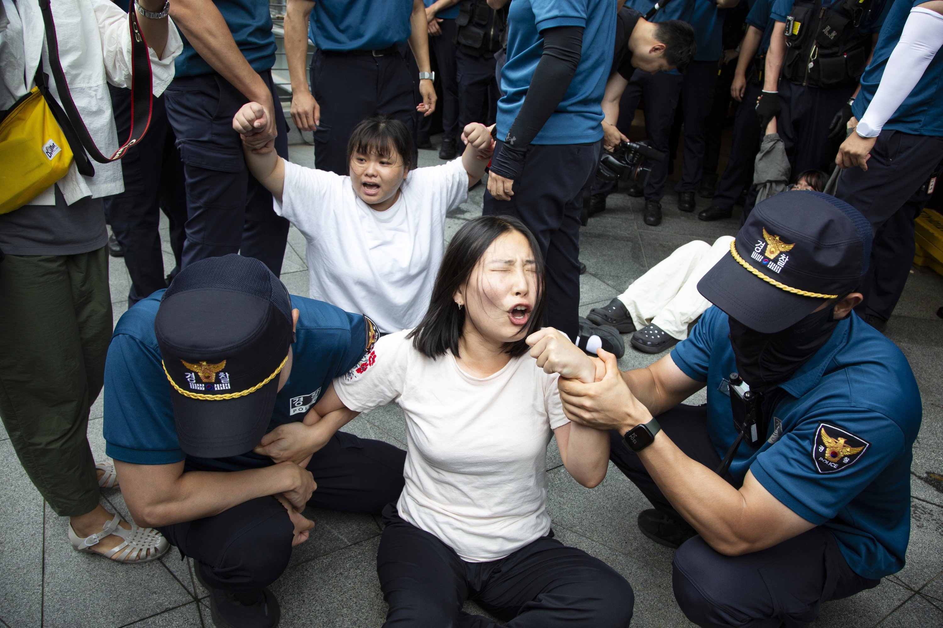 Police officials detain protesters as they try to enter the Japanese embassy amid a rally in Seoul, South Korea, Aug. 24, 2023. (EPA Photo)