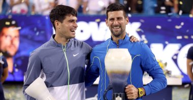 Spain&#039;s Carlos Alcaraz (L) and Serbia&#039;s Novak Djokovic pose with their trophies after the final of the Western & Southern Open at Lindner Family Tennis Center, Ohio, US., Aug. 20, 2023. (AFP Photo)
