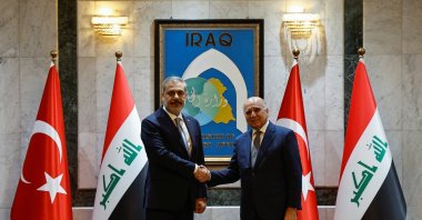 Foreign Minister Hakan Fidan (L) shakes hands with his Iraqi counterpart Fuad Hussein, Baghdad, Iraq, Aug. 22, 2023. (Reuters Photo)
