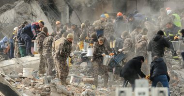 The rescue teams remove bodies from the debris of destroyed buildings in Gaziantep, Türkiye, Feb. 6, 2023. (AA Photo)
