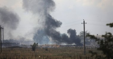 This file photo shows smoke rising over the site of an explosion near the village of Mayskoye, Crimea, Russia occupied Ukraine, Aug. 16, 2022. (AP Photo)
