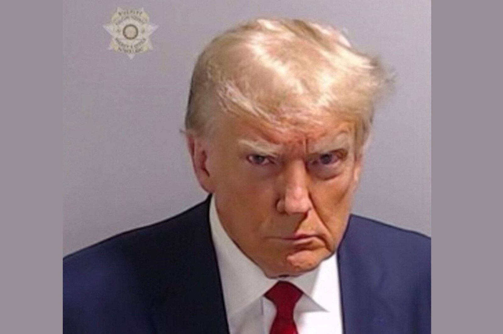 Trump’s historic mug shot released after election case arrest