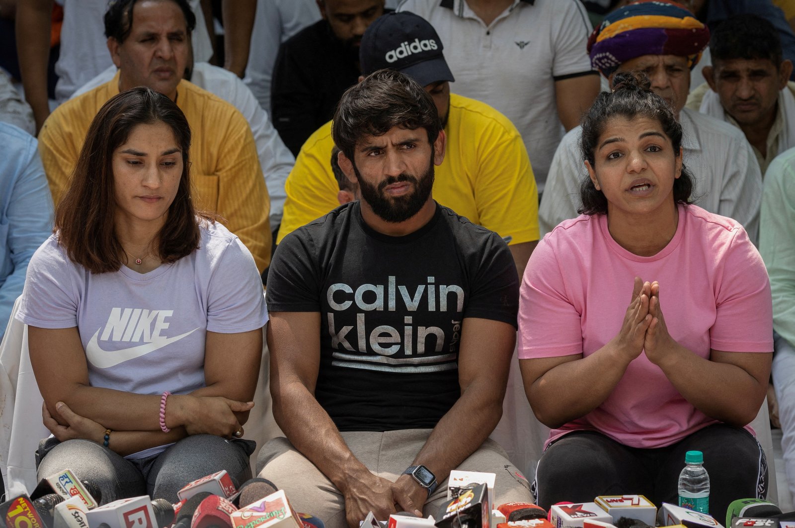 Indian wrestlers Vinesh Phogat (L), Bajrang Punia (C), and Sakshi Malik address a news conference as they take part in a sit-in protest demanding the arrest of Wrestling Federation of India (WFI) chief, who they accuse of sexually harassing female players, New Delhi, India, April 24, 2023. (Reuters Photo)