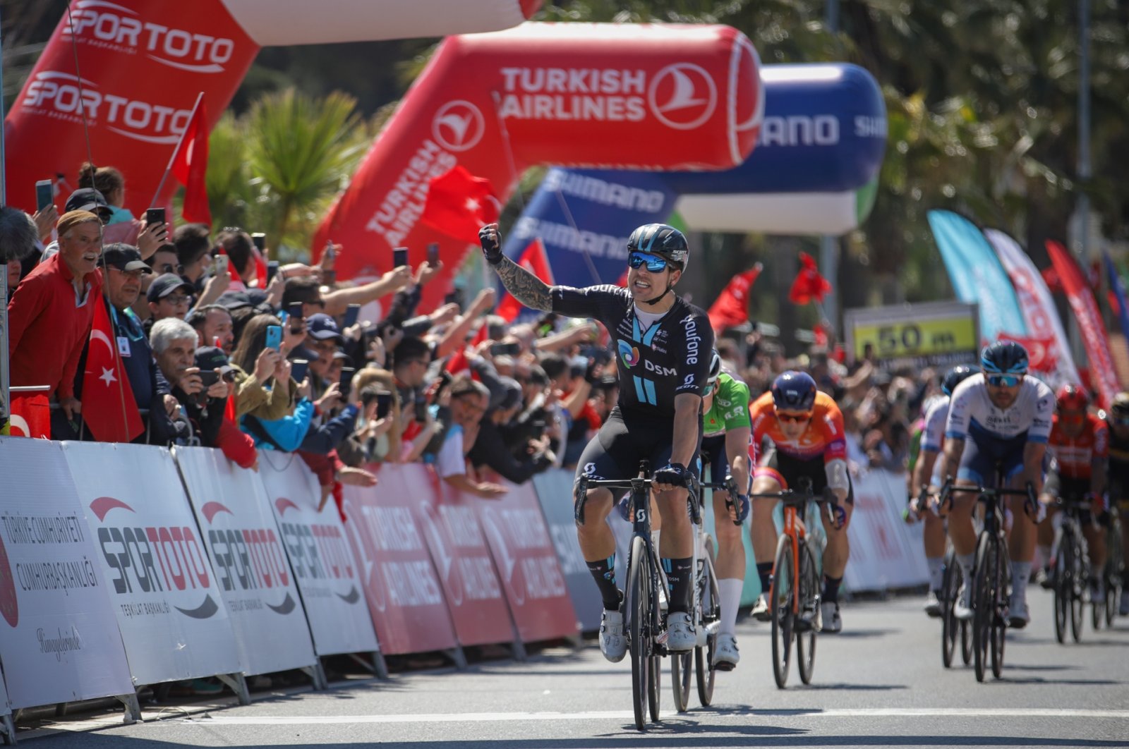 The photo shows cyclists waving spectators, Istanbul, Türkiye, April 14, 2023. (DHA Photo)