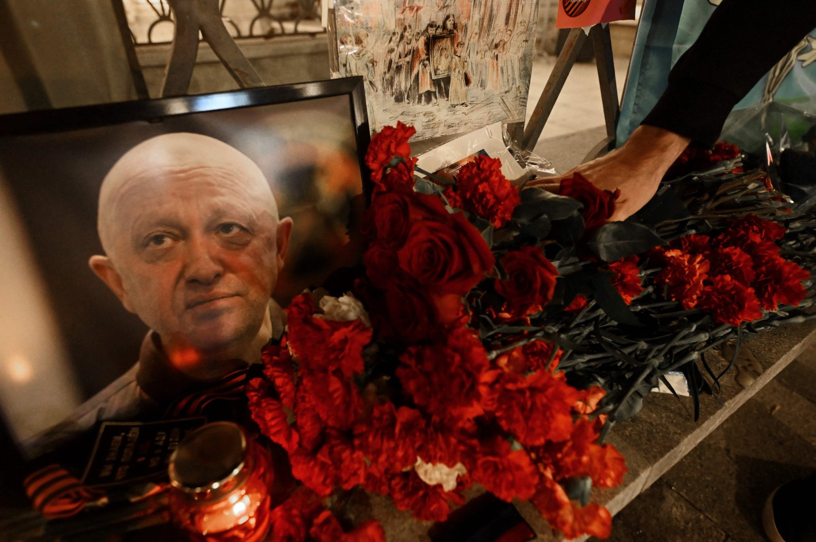 A man lays flowers at the makeshift memorial in honor of Yevgeny Prigozhin, in Moscow, Russia, Aug. 24, 2023. (AFP Photo)