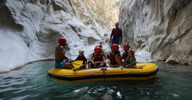 A group of tourists, accompanied by a guide, transcends through chilly waters of thrilling Göynük Canyon, Antalya, southern Türkiye, Aug. 27, 2023. (AA Photo)