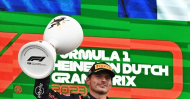 Red Bull Racing's Dutch driver Max Verstappen celebrates with the trophy on the podium after winning the Dutch Formula One Grand Prix race at The Circuit Zandvoort, Zandvoort, Netherlands, Aug. 27, 2023. (AFP Photo)