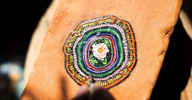 Ben Wilson shows his painting on a piece of chewing gum, stuck on a brick, in his home studio in Muswell Hill, London, U.K., Aug. 21, 2023. (Reuters Photo)