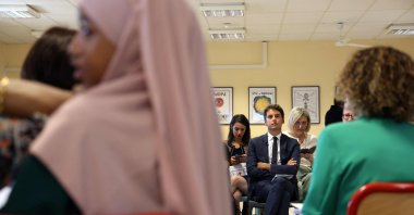 French Education Minister Gabriel Attal (C) attends a meeting at a school in Saint-Denis-de-la-Reunion, France, Aug. 17, 2023. (AFP Photo)