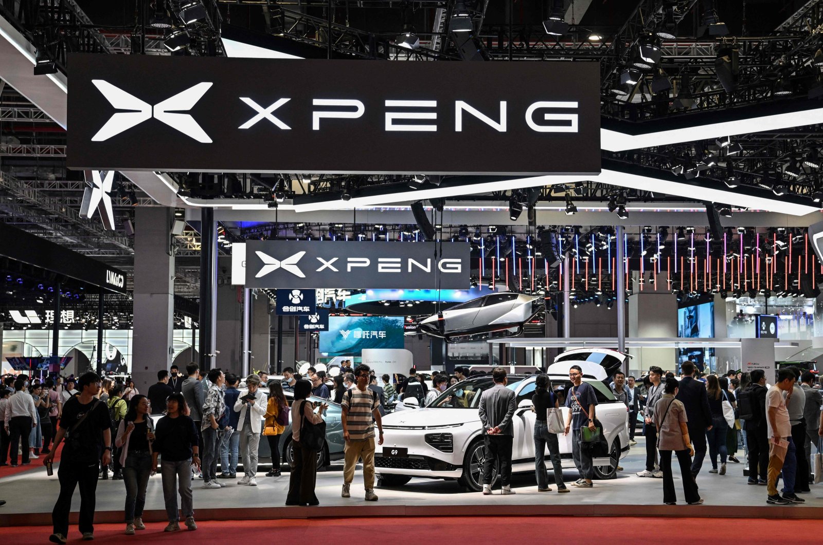 People visit the XPeng booth during the 20th Shanghai International Automobile Industry Exhibition in Shanghai, China, April 19, 2023. (AFP Photo)