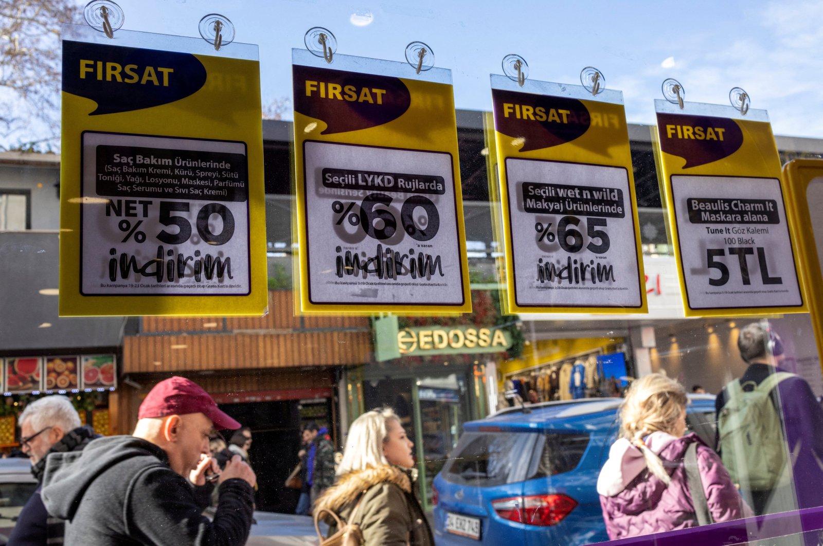 People walk past a shop advertising sales in Istanbul, Türkiye, Jan. 19, 2023. (Reuters Photo)