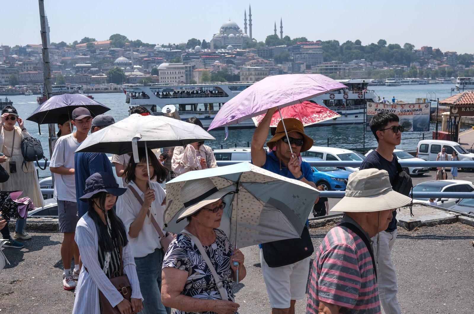 Tourists walk with umbrellas on a hot summer day in Istanbul, Türkiye, July 13, 2023. (EPA Photo)