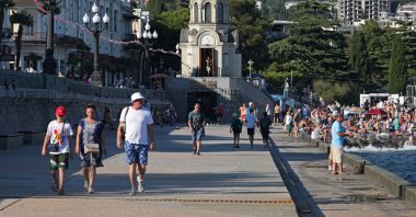 People walk along an embankment in Yalta, Crimea, Ukraine, Aug. 18, 2023. (Reuters Photo)