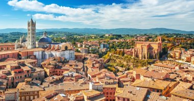 The scenery of Siena, a beautiful medieval town in Tuscany, with a view of the Dome and Bell Tower of Siena Cathedral. (Shutterstock Photo)