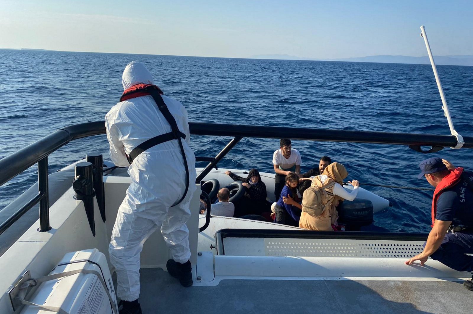 The Turkish coast guard pulls 19 irregular migrants to safety after rescuing them off the coast of the Ayvalık district of western Balıkesir province, Türkiye, Aug. 28, 2023. (AA Photo)