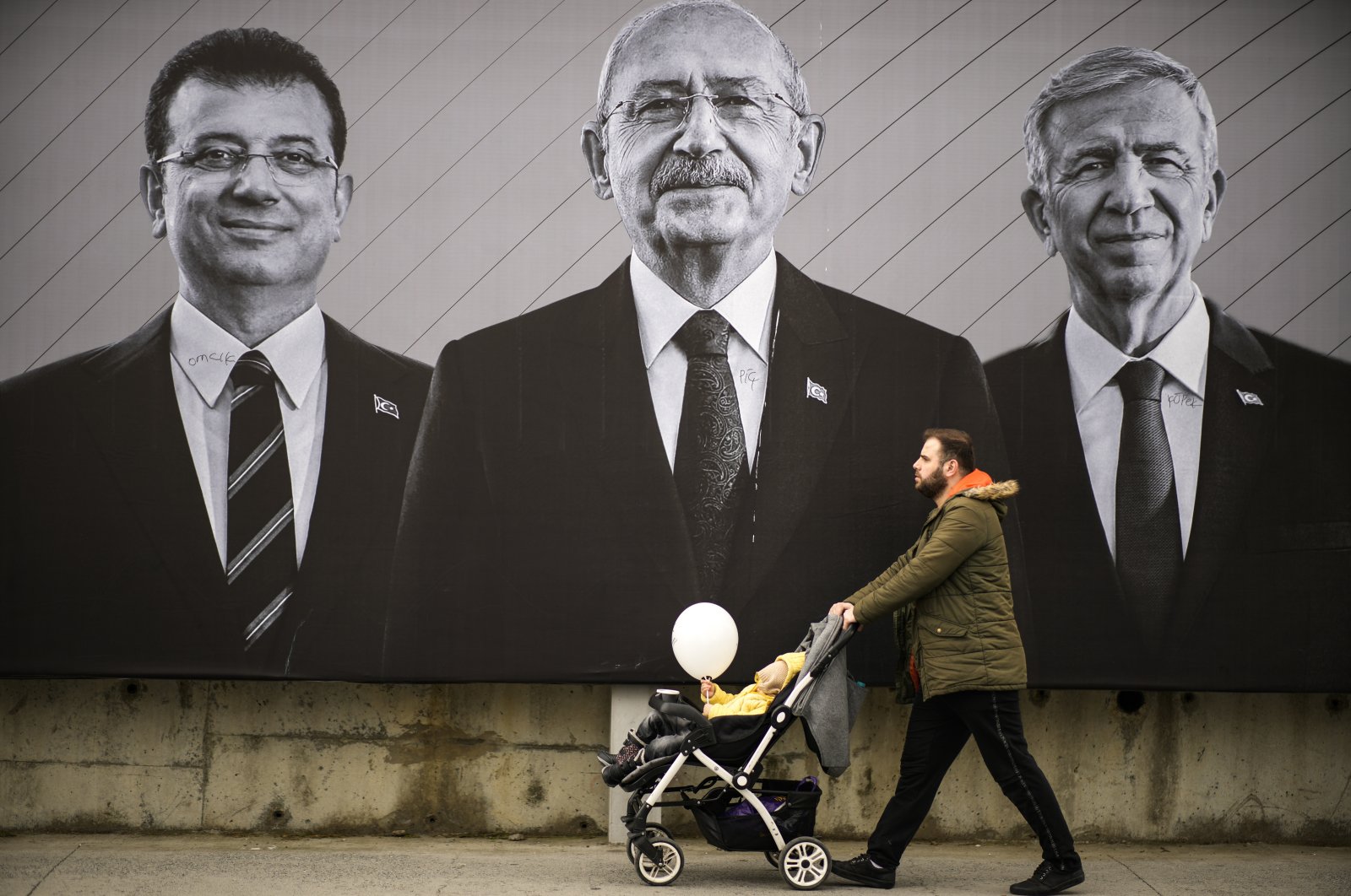 A man walks past a billboard of the main opposition Republican People&#039;s Party (CHP) chair Kemal Kılıçdaroğlu (C), Istanbul Mayor Ekrem Imamoglu (L) and Ankara Mayor Mansur Yavas, in Istanbul, Türkiye, May 6, 2023. (AP Photo)