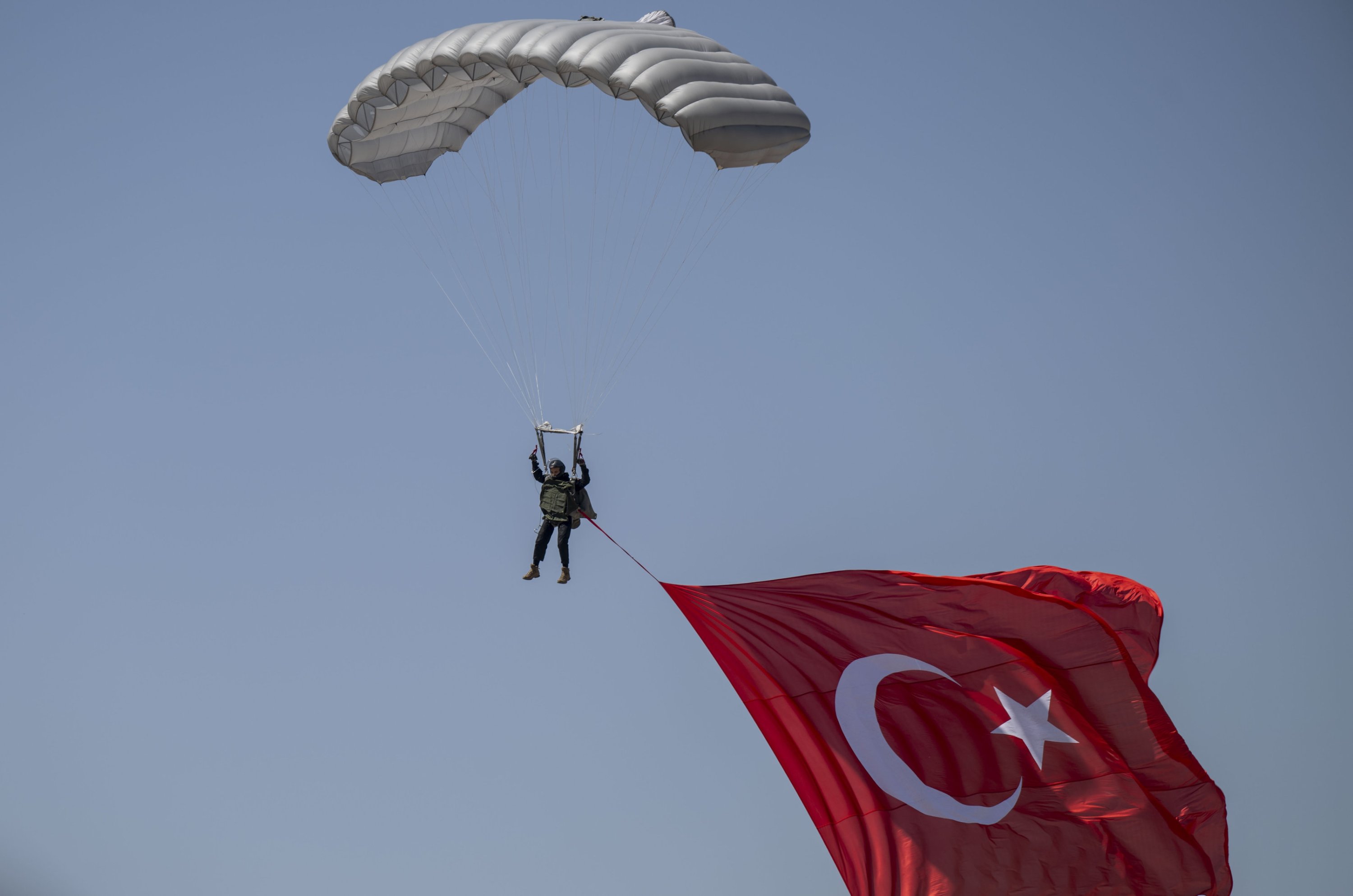 The man on parachute is seen raising large Turkish flag as part of Teknofest, Türkiye's premier aerospace and technology festival, Ankara, Türkiye, Aug. 30, 2023. (AA Photo)