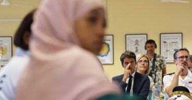 French Education Minister Gabriel Attal (C) attending a meeting at the Bourbon High School in Saint-Denis-de-la-Reunion on the first day of school on the overseas island of La Reunion, France, Aug. 17, 2023 (AFP Photo)