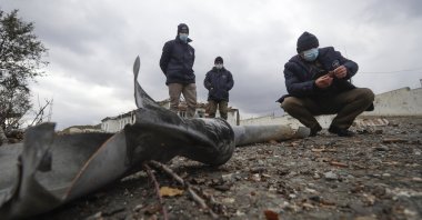 Members of the survey team from Halo Trust mine-clearing organisation examines unexploded items at an damaged ammunition store near Aeygestan, on the outskirts of Stepanakert, the capital of the separatist region of Nagorno-Karabakh, Nov. 23, 2020.  (AP Photo)