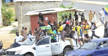 Residents driving in a vehicle celebrate and hold a Gabon national flag in Libreville, Gabon, Aug. 30, 2023. (AFP Photo)