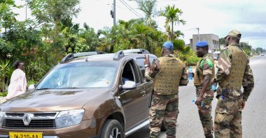Members of the security forces gesture to a driver, at a checkpoint in the streets of Akanda, Gabon, Aug. 30, 2023. (EPA Photo)