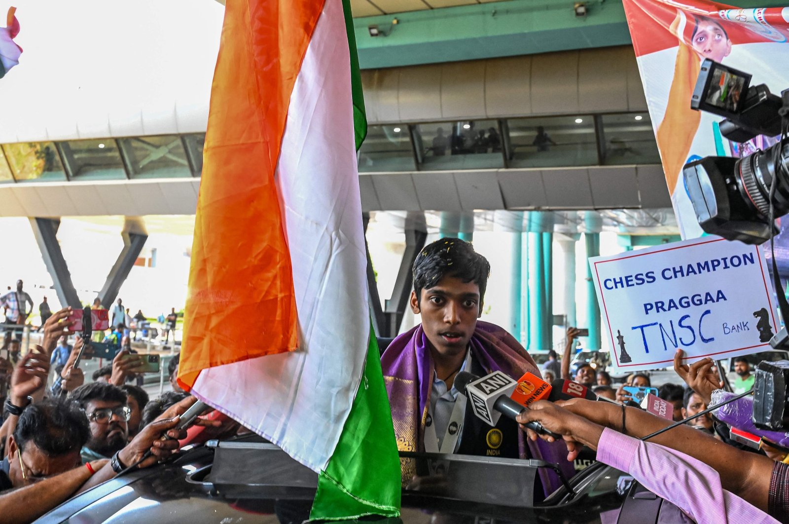 India&#039;s chess grandmaster and silver medallist Rameshbabu Praggnanandhaa, responds to a television media personnel as he is welcomed upon his return from the FIDE Chess World Cup in Baku, at the Chennai International airport, Chennai, India, Aug. 30, 2023. (AFP Photo)