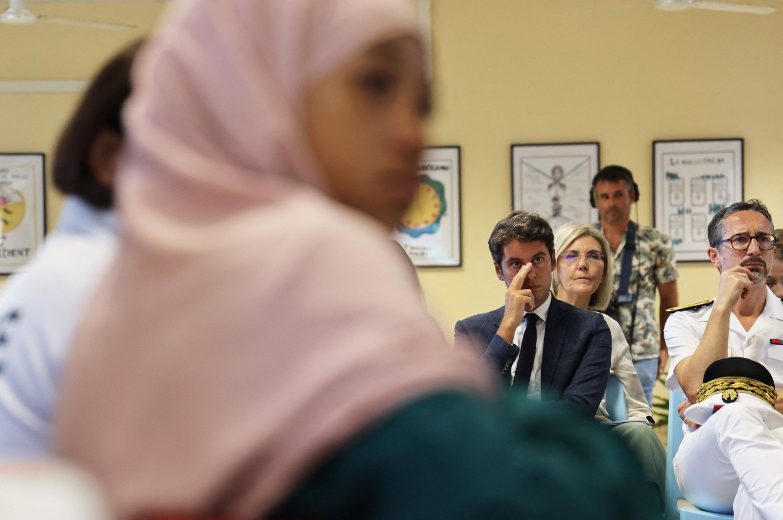 French Education Minister Gabriel Attal (C) attending a meeting at the Bourbon High School in Saint-Denis-de-la-Reunion on the first day of school on the overseas island of La Reunion, France, Aug. 17, 2023 (AFP Photo)