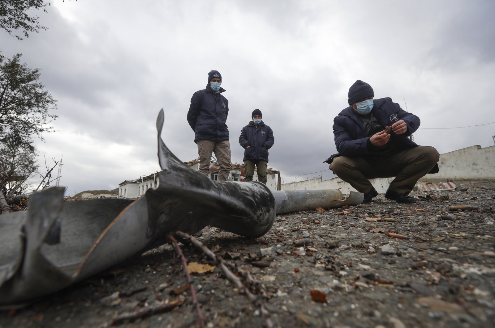 Members of the survey team from Halo Trust mine-clearing organisation examines unexploded items at an damaged ammunition store near Aeygestan, on the outskirts of Stepanakert, the capital of the separatist region of Nagorno-Karabakh, Nov. 23, 2020.  (AP Photo)