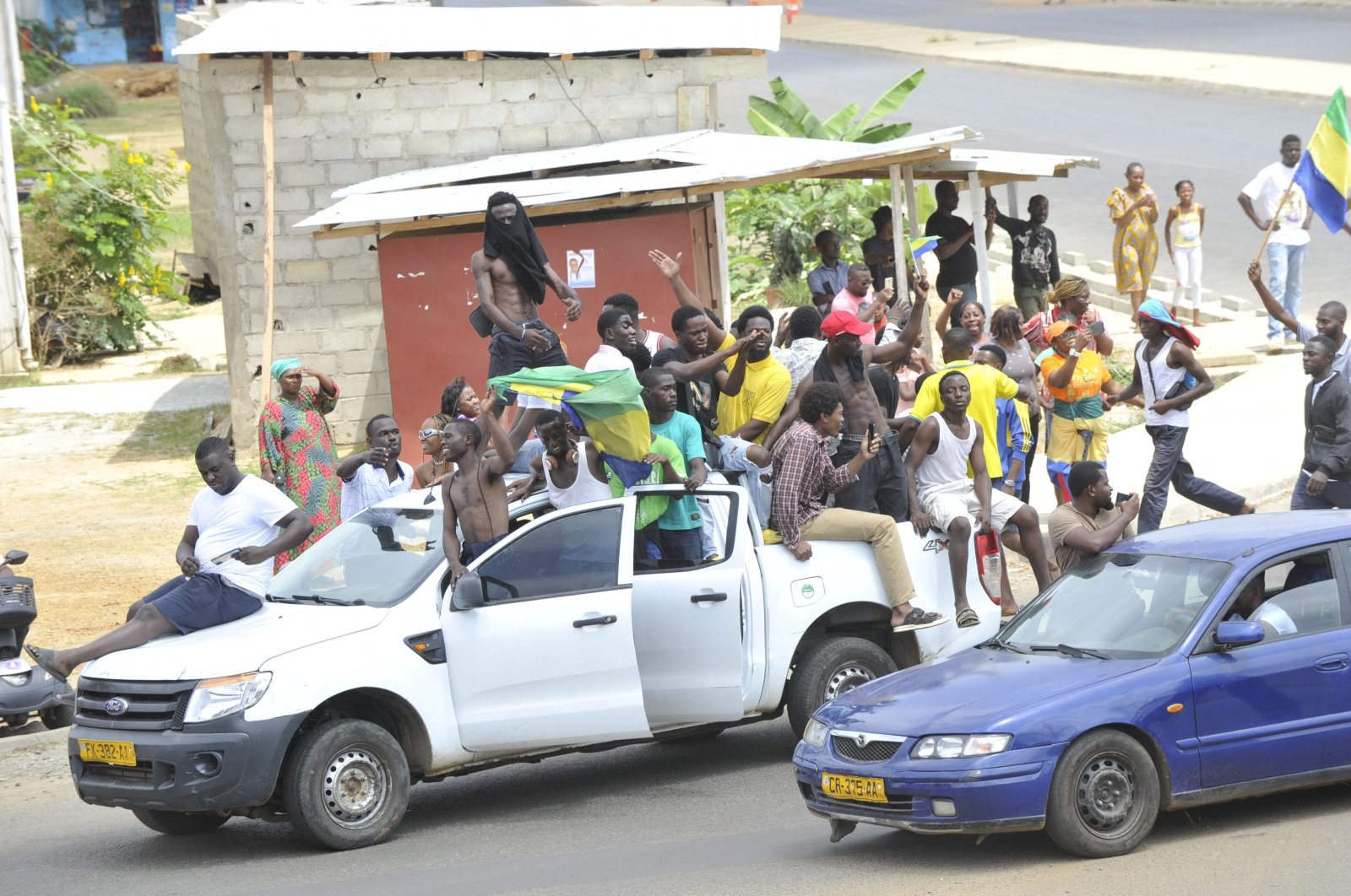 Residents driving in a vehicle celebrate and hold a Gabon national flag in Libreville, Gabon, Aug. 30, 2023. (AFP Photo)