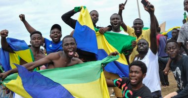 People wave Gabon national flags as they celebrate after a military coup, Akanda, Gabon, Aug. 30, 2023. (EPA Photo)