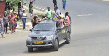 Residents driving in a vehicle celebrate and hold a Gabon national flag after a coup by Gabonese military officers, in Libreville, Gabon, Aug. 30, 2023. (AFP Photo)