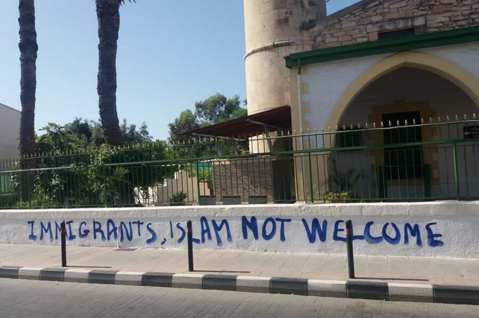 The garden wall of the Köprülü Hacı Ibrahim Ağa Mosque reads "Immigrants, Islam not welcome" in spray paint after a perpetrator attacked the mosque, in Limassol, Greek Cyprus, Aug. 26, 2023. (AA Photo)