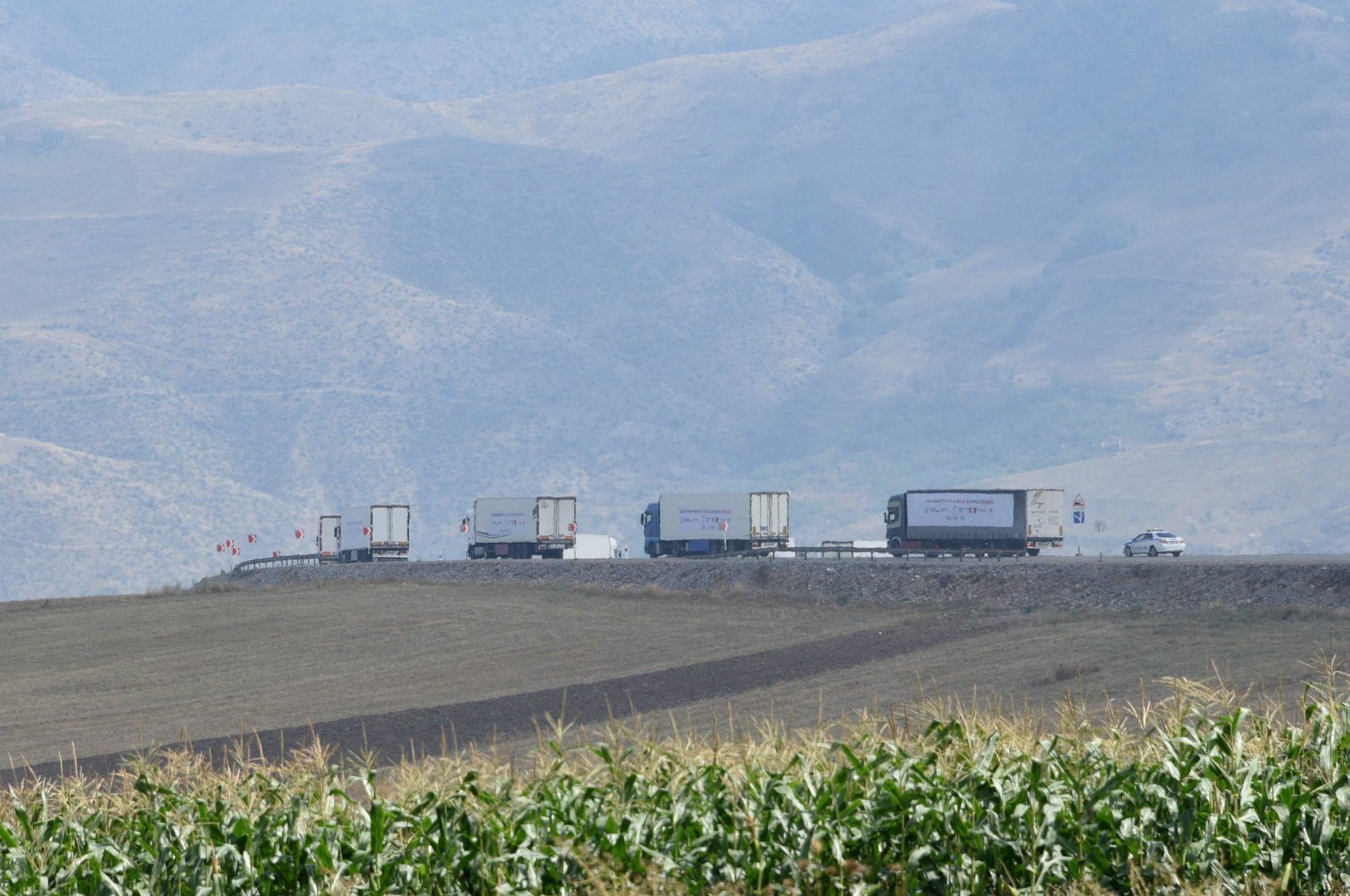 Lorries carrying French aid for the Armenian-populated Karabakh region move in the direction of the Lachin corridor, Azerbaijan, on August 30, 2023. (AFP Photo)