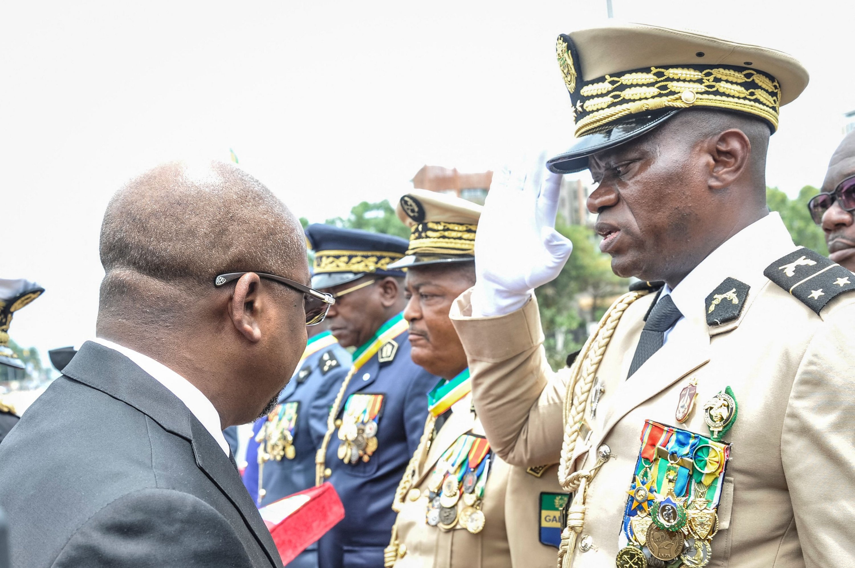 Head of Gabon's elite Republican Guard, General Brice Oligui Nguema (R), is decorated by Gabon Prime Minister Alain Claude Bilie Bie Nze (L) during celebrations ahead of Gabon Independence day celebrated, Libreville, Gabon, Aug. 16, 2023. (AFP Photo)